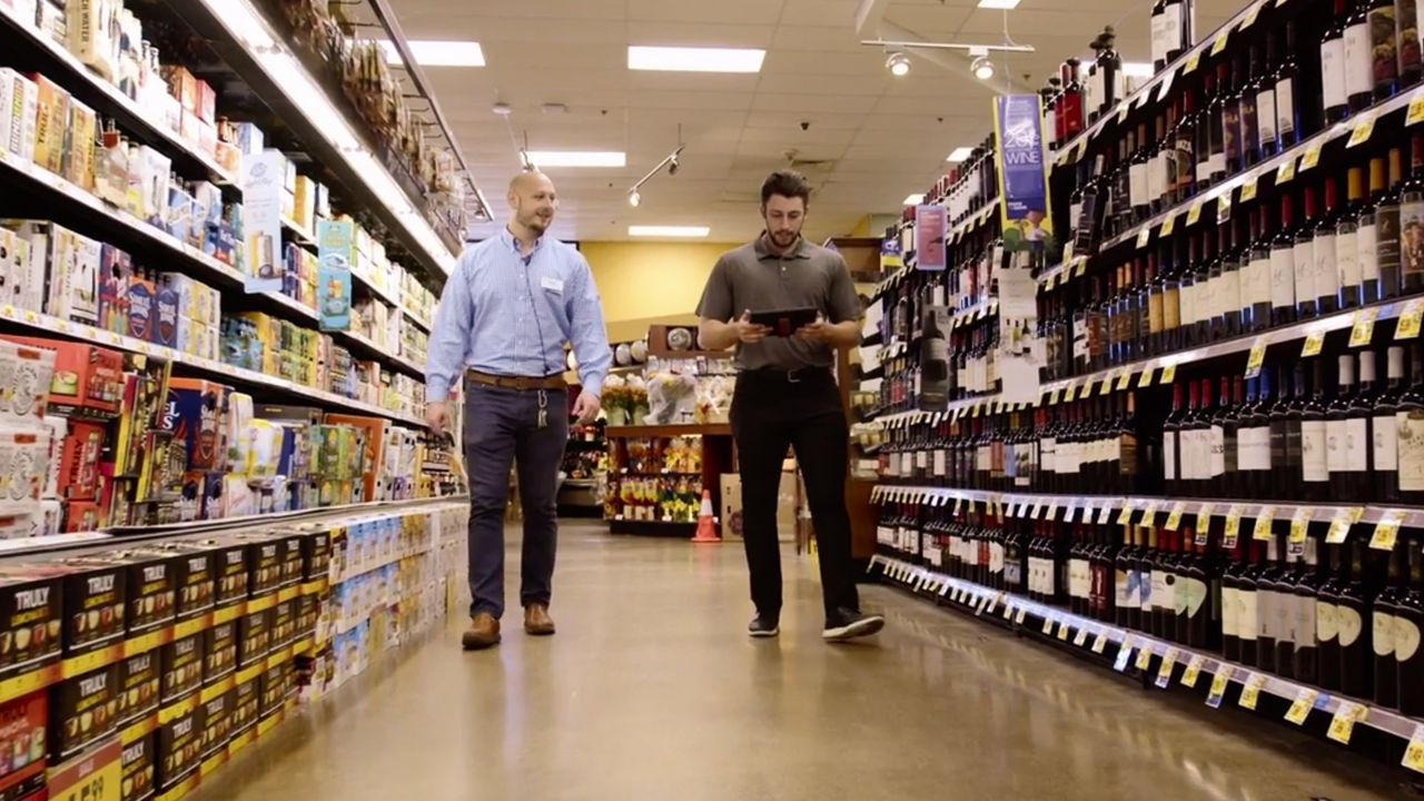 industry experts walk through a grocery store aisle